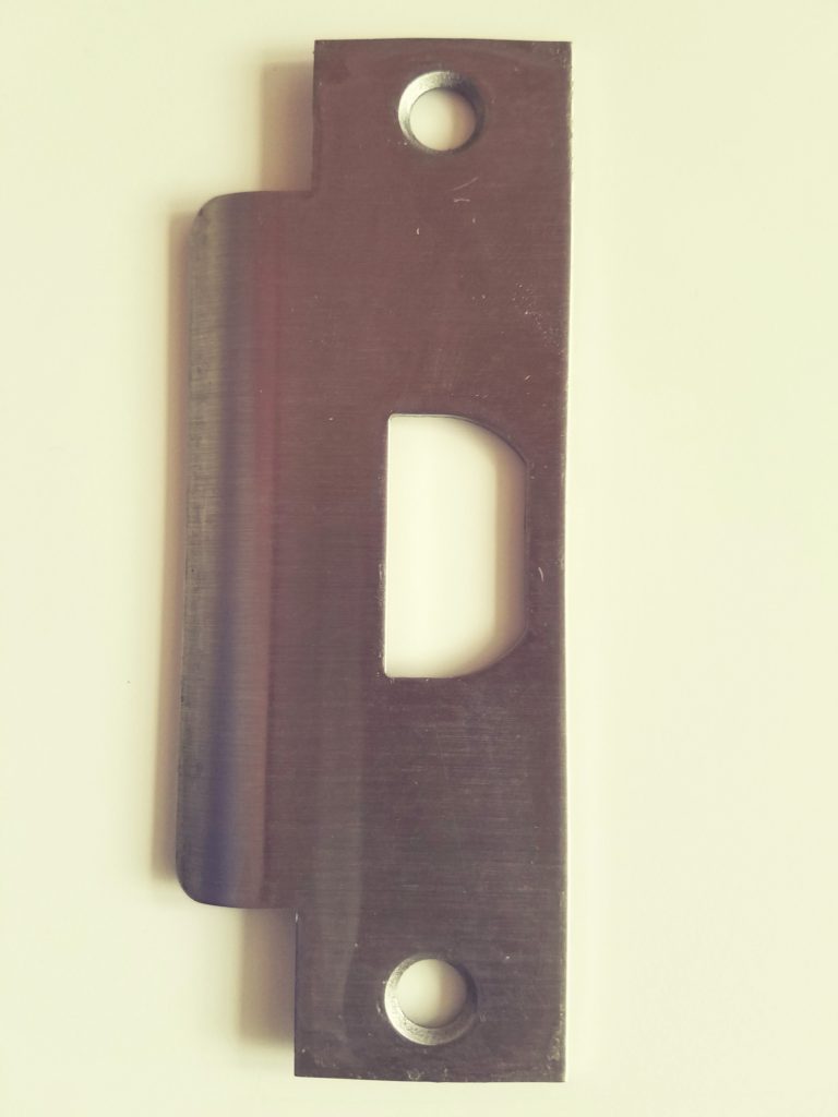 Steel strike plate used in commercial door frame installations and lock repairs.