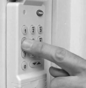 Garage door keypad entry system being programmed for wireless access control in Denver