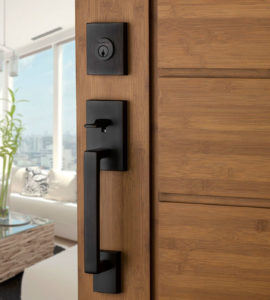 Modern front door with keyed deadbolt and handle set, commonly rekeyed in residential homes.