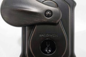 Decorative front door lock with thumb turn and keyed cylinder, commonly rekeyed in upscale residential properties.