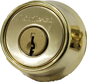 Close-up of a Kwikset deadbolt lock cylinder commonly rekeyed in residential properties.