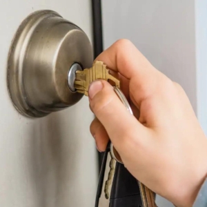 Locksmith performing on-site rekeying service for residential door locks.